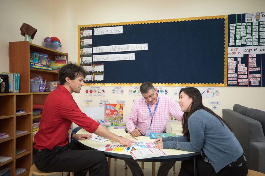 creative arts in background with 3 professors